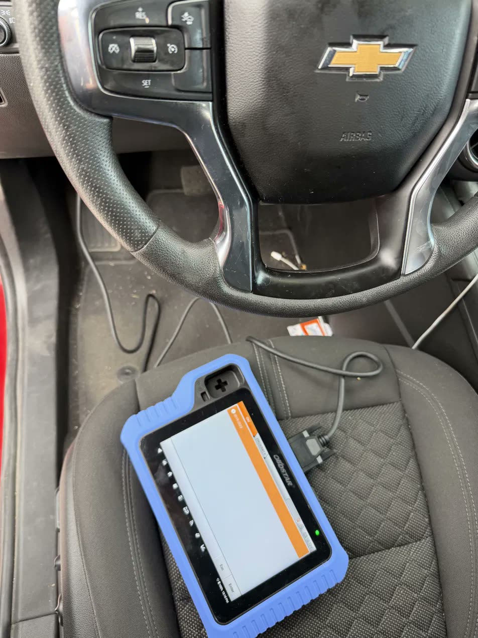 David's key programmer hooked up inside a Chevy during transponder and fob programming