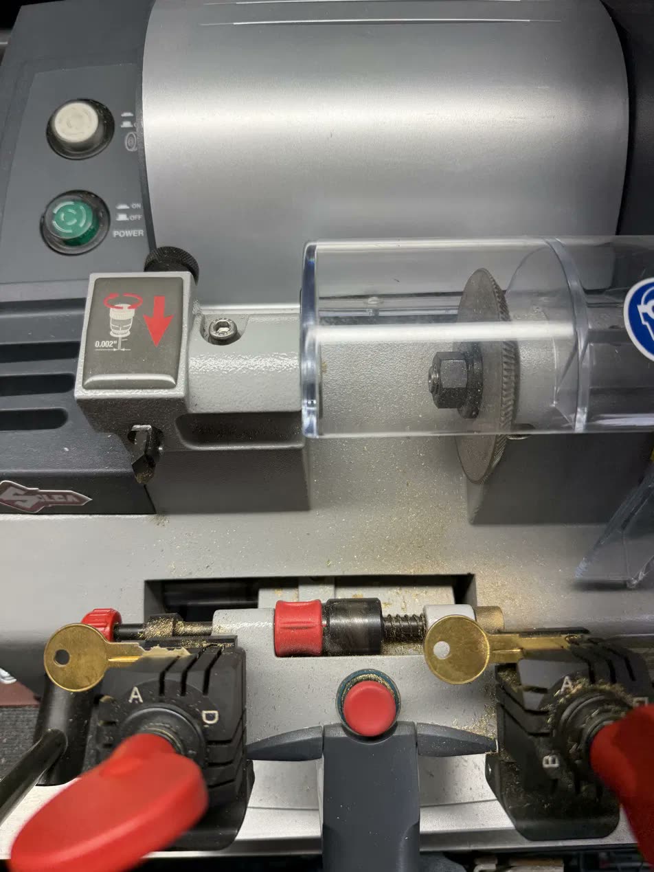 Brass keys clamped in David's Silca key cutting machine